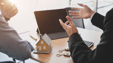 Cropped shot of Business people negotiating about interest to invest in real estate and home buying in modern meeting room
