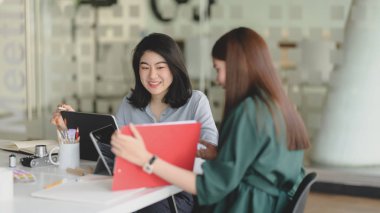 Cropped shot of team application developer consulting on their project  in modern meeting room 