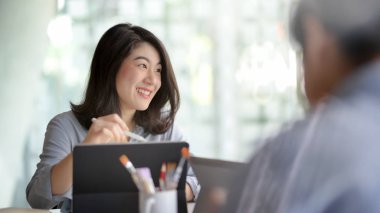 Side view of businessman using laptop on his lap in simple co working space