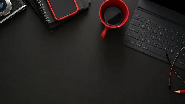 Stylish workplace with wireless keyboard, smartphone, copy space and coffee cup on black table — Stock Photo, Image