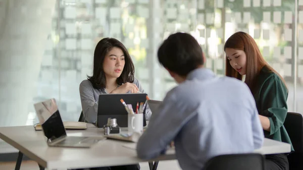 Cropped shot of team application developer consulting on UI project  in modern co working space