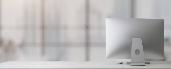 Close up view of simple workplace with  computer and copy space on white table in glass partition office room