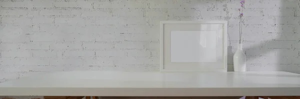 Close up view of minimal interior design with mock-up frame, ceramic vase and copy space on white table with white brick wall