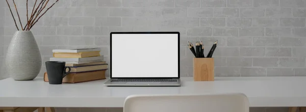白い椅子で白い机の上にモックアップノートパソコン 文房具や本で簡単な作業台のビューを閉じます — ストック写真