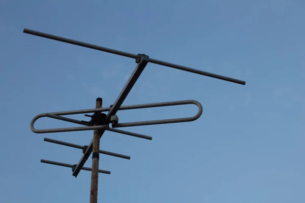 View of Television antenna on the roof top with blue sky background — 스톡 사진