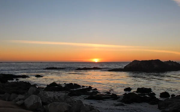 Hermosa vista de la puesta de sol desde Pebble Beach en el condado de Monterey, California. Playa de guijarros es parte de 17-Mile Drive, que es una carretera panorámica a través de Pacific Grove . — Foto de Stock