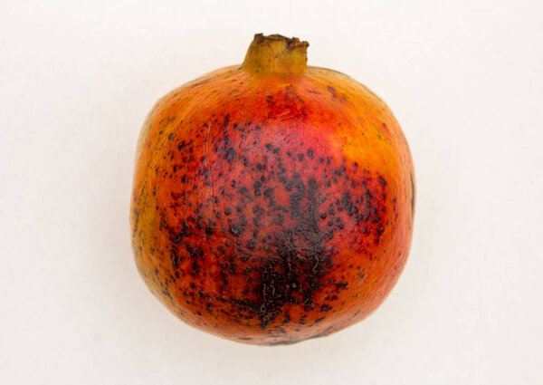 Top view of a ripe pomegranate isolated with white background