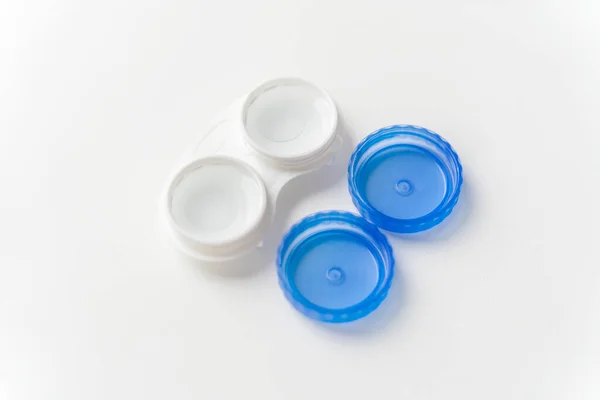 Contact lenses are in solution in contact lens container on a light background. Contact lenses for correcting vision.