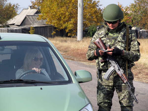 SELIDOVO, UKRAINE - OCTOBER, 2014: Armed with a Soviet Kalashnikov assault rifle Ukrainian border guard 