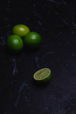 Lime cut in half on a dark distressed background