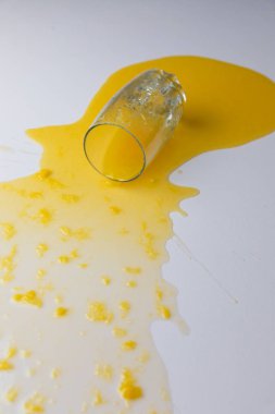 Fresh Orange juice spilled on a white table