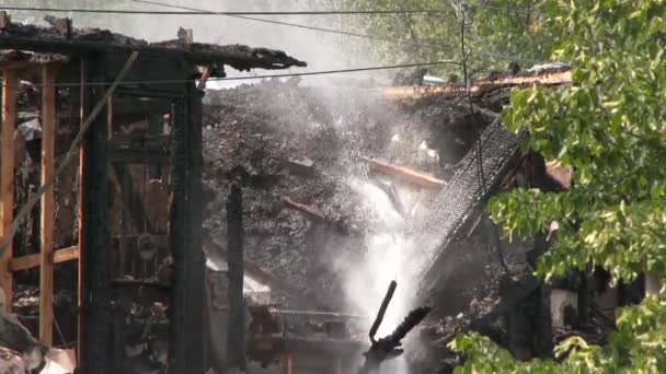 Water Jet Splashing Burnt Out Tar Roof House — Stock Video