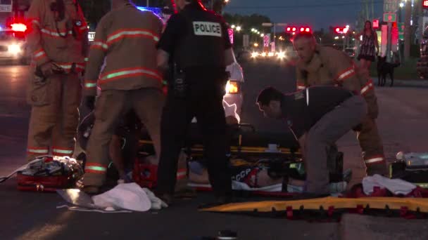 Slow Motion - Paramedics lifting female on spinal board onto a stretcher