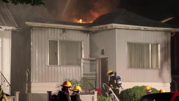 Fireman Pulling Hose Single Story House Ablaze Evening — Stock Video