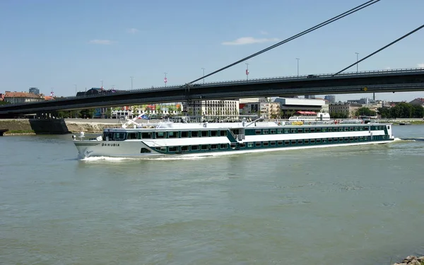 Cruise ship DANUBIA underway on the Danube River under the New Bridge, Bratislava, Slovakia - June 29, 2011
