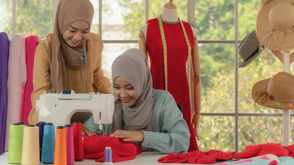 Muszlim női szabó hidzsábon dolgozik divattervező boltban — Stock Fotó