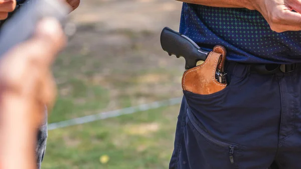 handgun in gun holster in man pocket