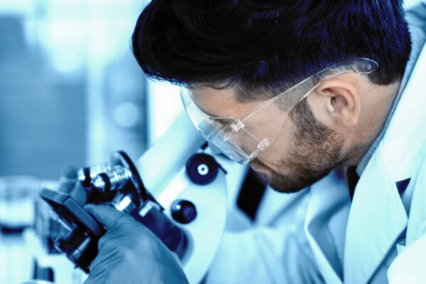 blurred scient background of scientist reseacher using microscope in laboratory