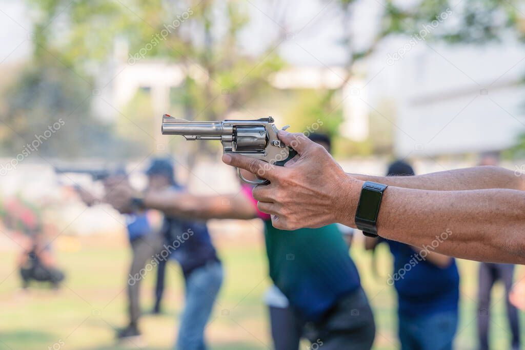 man hands holding and fire hand gun in gun shooting competition