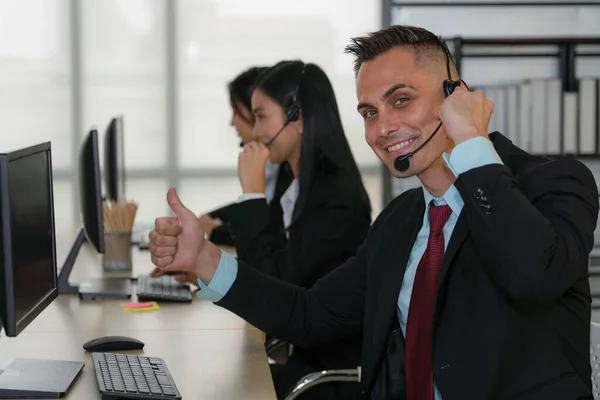caucasian help desk and call center agent working at customer service operation center