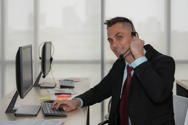 caucasian help desk and call center agent working at customer service operation center