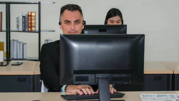 caucasian help desk and call center agent working at customer service operation center