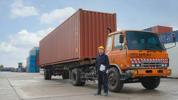 truck driver standing by container truck at containers yard and cargo