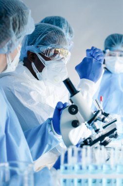 Aşı geliştirme laboratuvarında çalışan Africam Amerikan biyoloji araştırmacısı ve ekibi Coronavirus covid-19 aşısını geliştirmek için birlikte çalışıyorlar.