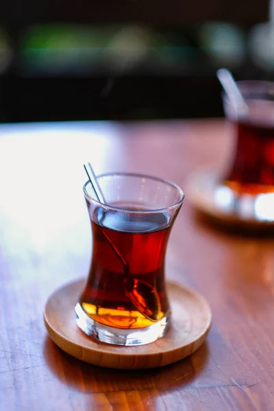 Traditional Turkish Two Tea on Wooden Table. Traditional Turkish Tea blur  background. Turkish Tea bokeh background.