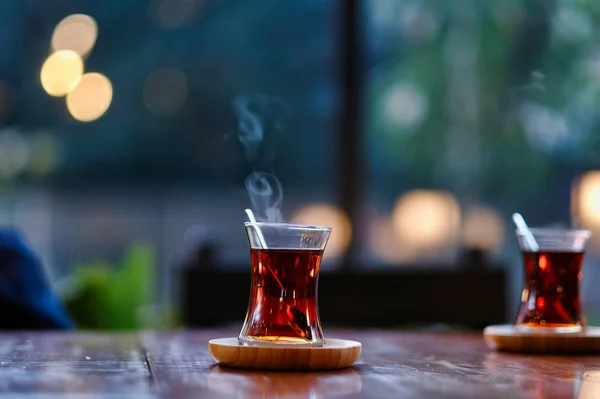 Traditional Turkish Two Tea on Wooden Table. Traditional Turkish Tea blur  background. Turkish Tea bokeh background.