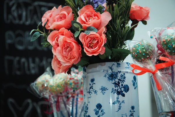 Flowers and candy on a stick — Stock Photo, Image