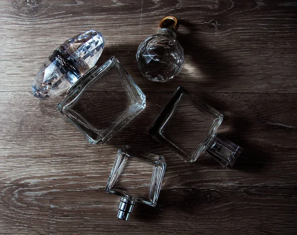 Frascos de perfume diferentes no fundo escuro — Fotografia de Stock
