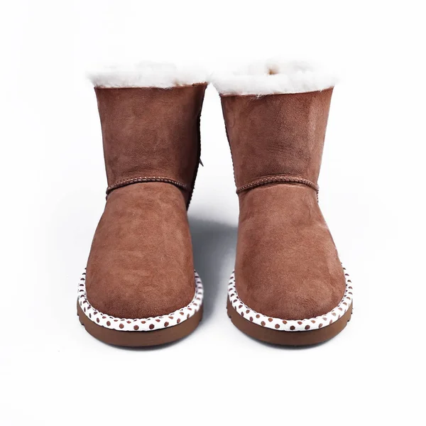 Australian Trendy winter shoes. Fur women\'s boots on white backg