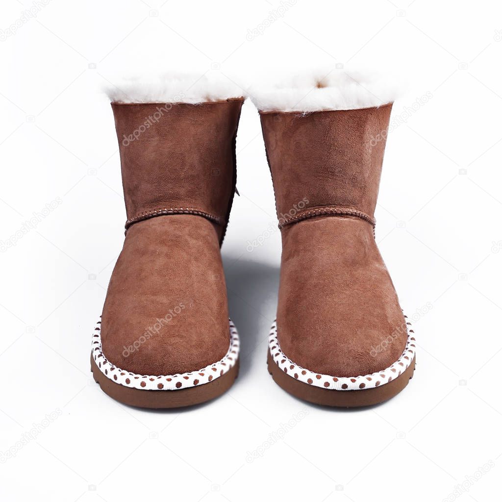 Australian Trendy winter shoes. Fur women's boots on white backg