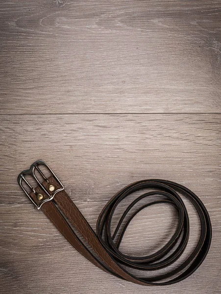 Cinturones de cuero en fondo de madera — Foto de Stock