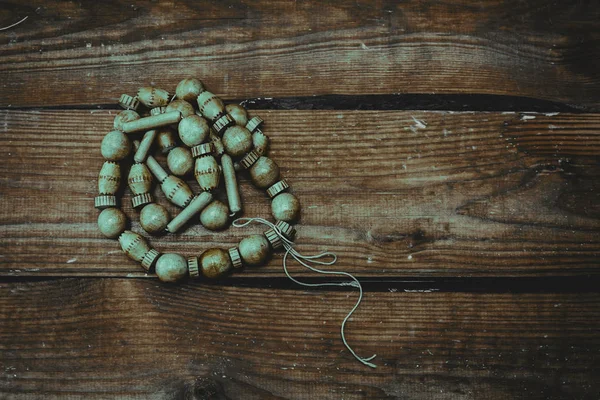 Stylish beads over wooden background close up — Stock Photo, Image