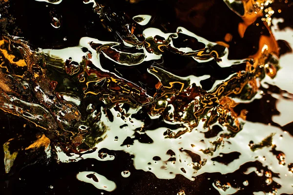 Liquid gold background. Abstract gold water waves with reflectio