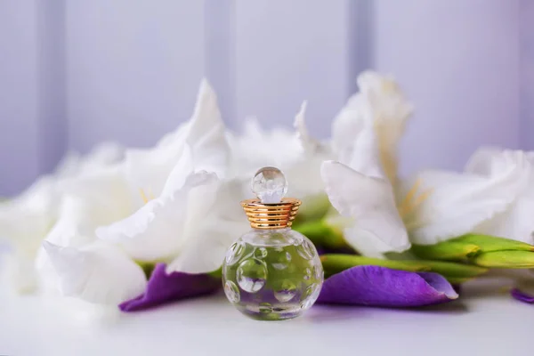 small bottle of perfume with white flowers
