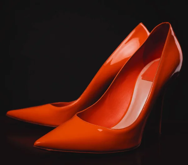 Female orange shoes over black — Stock Photo, Image