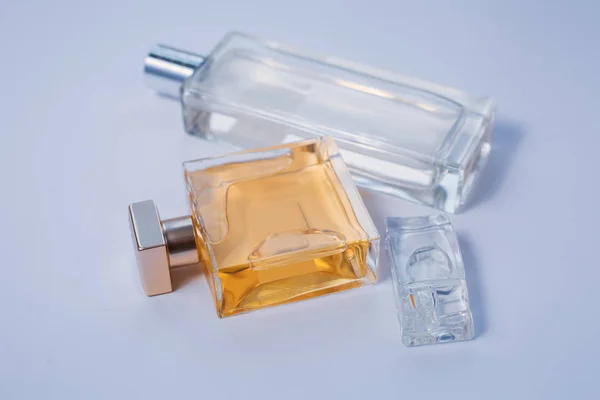 Three bottles of perfumes over grey — Stock Photo, Image