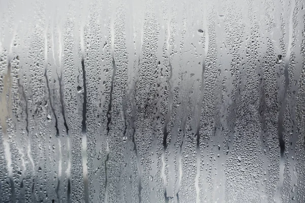 Misted window glass in drops of water as a background — Stock Photo, Image