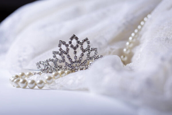 Tiara and white pearls with wedding dress