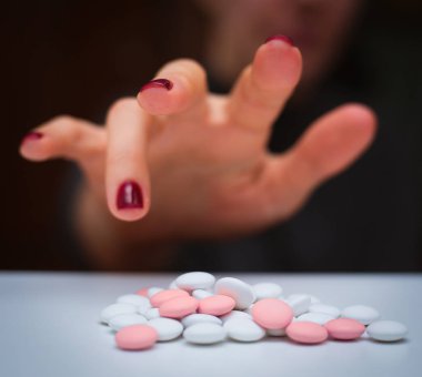 Depression and problem. Hand surrounded by many pills. clipart