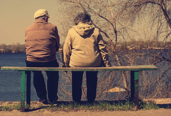 Paar sitzt auf einer ländlichen Landschaft — Stockfoto