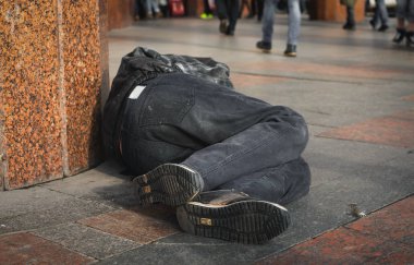 Sokakta uyuyan pis evsiz adam.