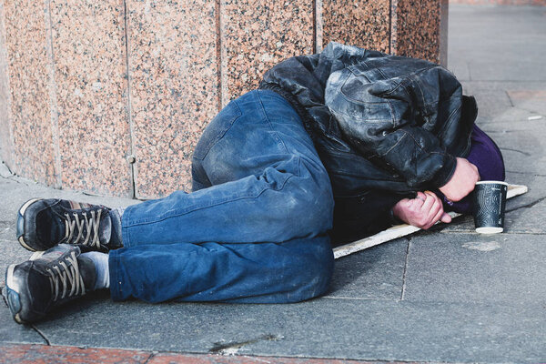 homeless man sleeping on the street