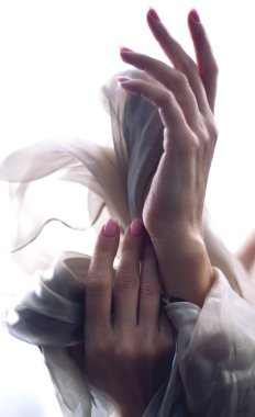 Female hands and silk fabric. Skin Care Symbol