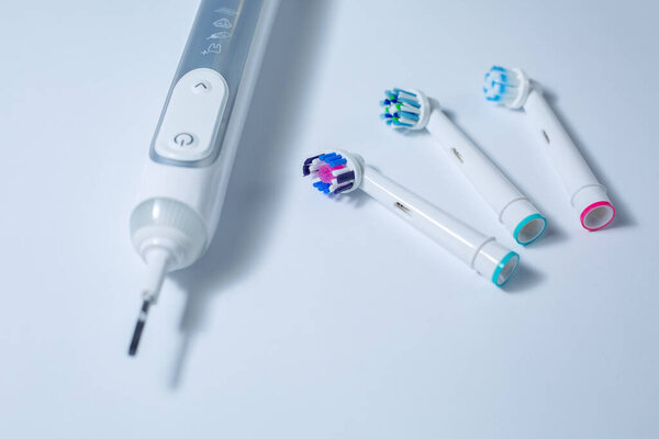 Modern Electric Toothbrush with a Few Spare Heads 