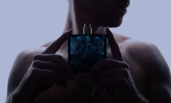Man and perfume on blue background