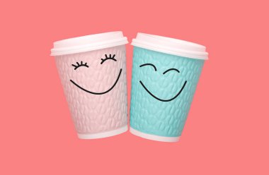 İki kahve fincanı ve pembe arka planda gülümseyen bir kadın ve erkek. Mutlu Sevgililer Günü kavramı.